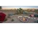 Charming firepit area with built-in seating and desert landscaping at 23861 N 74Th Pl, Scottsdale, AZ 85255