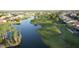 Aerial view of a community with houses, golf course, and lake at 23901 S Vacation Way, Sun Lakes, AZ 85248