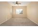 Well-lit bedroom with ceiling fan and neutral carpeting at 23901 S Vacation Way, Sun Lakes, AZ 85248