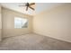 Well-lit bedroom with carpeted floor and ceiling fan at 23901 S Vacation Way, Sun Lakes, AZ 85248