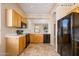 Open kitchen with wood cabinets and black appliances at 23901 S Vacation Way, Sun Lakes, AZ 85248