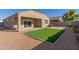 Landscaped backyard with artificial turf and patio at 2455 E Alida Trl, Casa Grande, AZ 85194