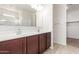 Double vanity bathroom with dark brown cabinets and a large mirror at 2455 E Alida Trl, Casa Grande, AZ 85194