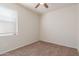 Simple bedroom with ceiling fan and window at 2455 E Alida Trl, Casa Grande, AZ 85194