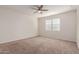 Well-lit bedroom with ceiling fan and neutral color walls at 2455 E Alida Trl, Casa Grande, AZ 85194