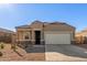 Single-story home with a two-car garage and desert landscaping at 2455 E Alida Trl, Casa Grande, AZ 85194