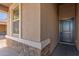 Gray front door with stone accents and a covered entryway at 2455 E Alida Trl, Casa Grande, AZ 85194