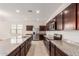 Spacious kitchen with dark wood cabinets and granite countertops at 2455 E Alida Trl, Casa Grande, AZ 85194