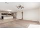 Spacious living room with neutral carpeting and ceiling fan at 2455 E Alida Trl, Casa Grande, AZ 85194