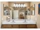 Double vanity bathroom with large mirror and updated fixtures at 2509 W Straight Arrow Ln, Phoenix, AZ 85085