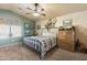 Bright bedroom with king bed, wood dresser, and ceiling fan at 2509 W Straight Arrow Ln, Phoenix, AZ 85085