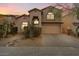 Two-story house with tan siding, attached garage, and desert landscaping at 2509 W Straight Arrow Ln, Phoenix, AZ 85085