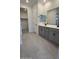 Main bathroom with double vanity and gray cabinets at 25312 W Bowker St, Buckeye, AZ 85326