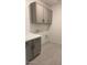 Laundry room with gray cabinets and tile floors at 25312 W Bowker St, Buckeye, AZ 85326