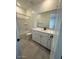 Well lit bathroom with a shower-tub combo and white double vanity at 25318 W Bowker St, Buckeye, AZ 85326