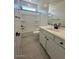 Modern bathroom with a shower-tub combo and white single vanity at 25318 W Bowker St, Buckeye, AZ 85326