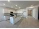 Modern kitchen with stainless steel appliances, granite countertops, and large center island at 25318 W Bowker St, Buckeye, AZ 85326