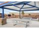 Community pavilion featuring steel picnic tables, stone columns, and desert landscaping at 25318 W Bowker St, Buckeye, AZ 85326