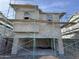 Front elevation view of new construction home showing scaffolding and an attached garage at 26111 N 23Rd Ave, Phoenix, AZ 85085