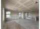 Spacious living room of a new construction home showing drywall and lots of light at 26111 N 23Rd Ave, Phoenix, AZ 85085