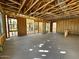 Unfinished living room with exposed wooden framing and concrete flooring at 26111 N 23Rd Ave, Phoenix, AZ 85085