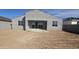 View of the home's backyard, featuring desert landscaping and a covered patio at 2657 E Abe Truckle Ave, San Tan Valley, AZ 85140