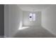 Empty bedroom featuring neutral walls, a large window, and bare floors at 2657 E Abe Truckle Ave, San Tan Valley, AZ 85140