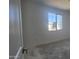 Bedroom featuring neutral walls, large window overlooking the neighborhood, and bare floors at 2657 E Abe Truckle Ave, San Tan Valley, AZ 85140