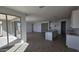 Open-concept living room with a kitchen island and sliding glass doors to the backyard at 2657 E Abe Truckle Ave, San Tan Valley, AZ 85140