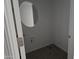 Powder room features neutral walls, wood-look tile floors and round mirror at 2657 E Abe Truckle Ave, San Tan Valley, AZ 85140