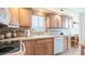 Kitchen with white appliances, wood cabinets, and a double sink at 288 Diamond Dr, Apache Junction, AZ 85119