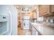 White appliances and a view into the adjacent living area at 288 Diamond Dr, Apache Junction, AZ 85119