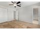 Bedroom with tile floors, ceiling fan, and access to bath at 2905 W Stella Ln, Phoenix, AZ 85017