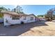 White ranch home with mature landscaping and a garage at 2905 W Stella Ln, Phoenix, AZ 85017