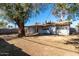 Back exterior view of the house showcasing a large yard at 2905 W Stella Ln, Phoenix, AZ 85017