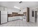 White kitchen features ample cabinetry and tile backsplash at 2905 W Stella Ln, Phoenix, AZ 85017