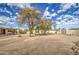 Large, sunny backyard with gravel ground cover and mature trees at 29619 N 60Th St, Cave Creek, AZ 85331