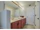 Bathroom with double sinks and updated red cabinets at 29619 N 60Th St, Cave Creek, AZ 85331