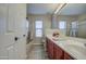 Bathroom with double sinks and updated red cabinets at 29619 N 60Th St, Cave Creek, AZ 85331