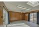 Spacious bonus room featuring wood paneling, tile floors, and dual sliding glass doors at 29619 N 60Th St, Cave Creek, AZ 85331