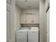 Laundry room with washer, dryer, and overhead cabinets at 29619 N 60Th St, Cave Creek, AZ 85331