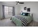 Guest bedroom with a ceiling fan and green bedding at 3077 W Ironwood Cir, Chandler, AZ 85226