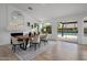 Bright dining room with hardwood floors, wood table, and access to the pool at 3077 W Ironwood Cir, Chandler, AZ 85226