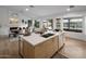 Modern kitchen with island, light wood cabinets, and stainless steel appliances at 3077 W Ironwood Cir, Chandler, AZ 85226