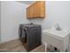 Convenient laundry room with washer, dryer, and utility sink at 3077 W Ironwood Cir, Chandler, AZ 85226