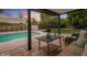 Relaxing patio with seating area overlooking the pool at 3077 W Ironwood Cir, Chandler, AZ 85226