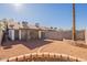 Backyard with gravel, block wall, and screened patio at 3344 E Crescent Ave, Mesa, AZ 85204