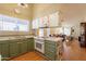 Galley kitchen with green cabinets and white appliances at 3344 E Crescent Ave, Mesa, AZ 85204