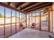 Relaxing screened porch with two red chairs and small table at 3344 E Crescent Ave, Mesa, AZ 85204