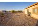 Large backyard with gravel and a few small trees at 34214 W Sahuaro St, Tonopah, AZ 85354